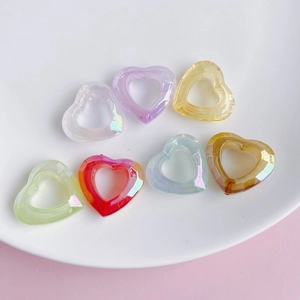 Close-up of faceted acrylic heart beads with colorful AB coating for DIY jewelry