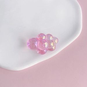 Close-up of pink aurora acrylic cloud charm with iridescent finish for DIY crafts