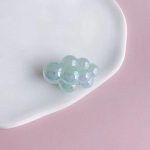 Macro shot of iridescent resin cloud charms with pearlescent finish for DIY jewelry crafts