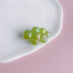 Detail of iridescent green bubble cloud acrylic charm for DIY jewelry and keychains