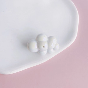 Close-up of pearl white acrylic cloud bead with center hole for DIY jewelry making