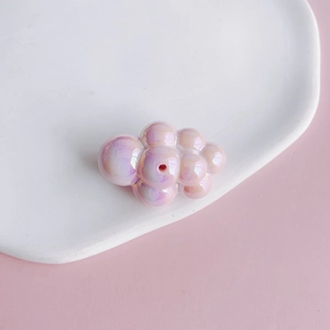 Macro shot of an aurora pink acrylic chubby cloud bead for DIY jewelry and phone chains