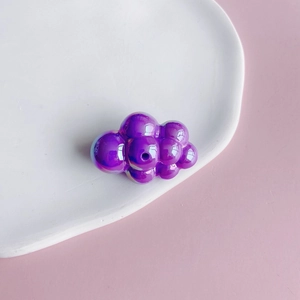Close-up of a purple iridescent bubble cloud acrylic bead with center hole for DIY crafts