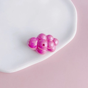Macro detail of iridescent magenta cloud acrylic bead for DIY jewelry making and keychains