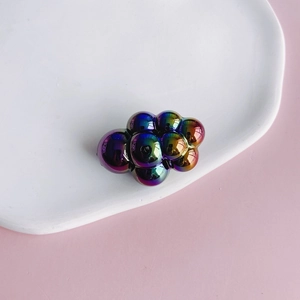 Close-up of chubby cloud charm with iridescent gradient finish and reflective surface