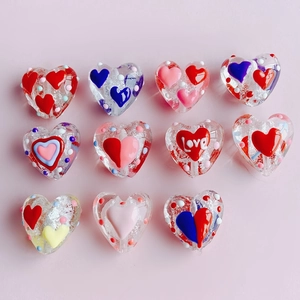 Detail of DIY heart beads with hand-painted dots and gold foil inner texture