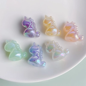 Close-up of colorful iridescent unicorn resin pendants for DIY jewelry making