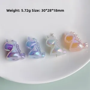 Detail view of 30x28mm iridescent unicorn resin charms in multiple pastel colors