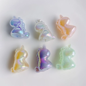 Detailed view of colorful 3D unicorn charms with iridescent pearl finish in six vibrant hues