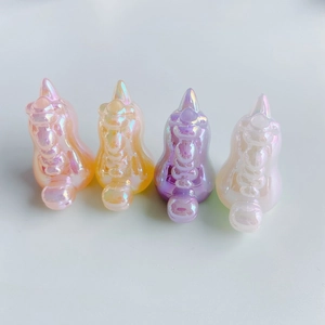 Macro shot of 4 pieces of unicorn resin charms with aurora rainbow finish for DIY jewelry