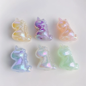 Detailed view of six colorful iridescent resin unicorn charms for DIY jewelry and crafts