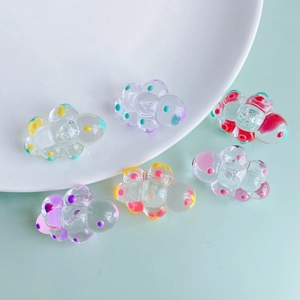 Chubby cloud DIY acrylic pendants with colorful polka dots on a light blue background