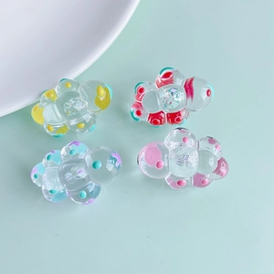 Detailed view of four colorful acrylic resin cloud charms for DIY jewelry making