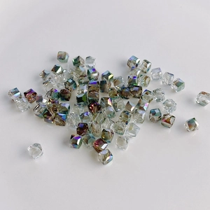 Detailed view of faceted geometric square crystal glass beads with AB iridescent finish