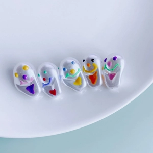 Macro detail of ghost resin pendants with colorful hand-painted faces for DIY jewelry making