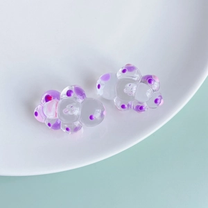 Detailed view of translucent resin cloud charms with pink and purple dots for DIY crafts