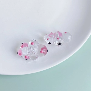 Detailed view of pink translucent resin cloud pendant with cute star eyes for DIY jewelry