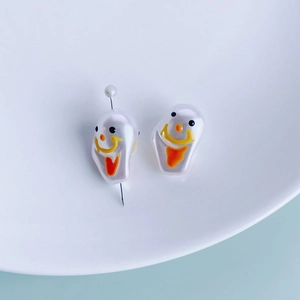 Close-up of irregular imitation pearl beads with painted ghost face for DIY jewelry