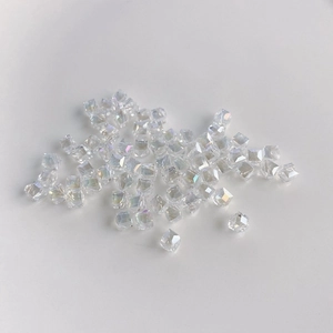 Macro shot of faceted clear AB crystal glass cube beads with rainbow light refraction