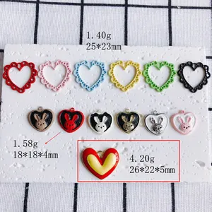 Assorted DIY jewelry charms featuring hollow hearts and painted rabbits in various colors