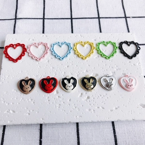 Flat lay of hollow heart frames and cute rabbit pendants for DIY jewelry making