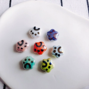 Star-shaped ceramic cat paw beads in seven bright colors for DIY jewelry making