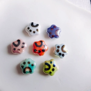 DIY ceramic star flower beads with cute cat paw patterns in vibrant glazed colors