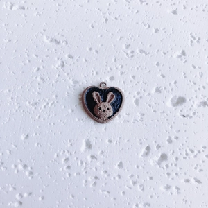 Macro detail of heart-shaped chocolate cookie rabbit pendant for DIY jewelry making