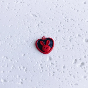 Detail of a red heart-shaped pendant featuring a 3D rabbit design for DIY jewelry