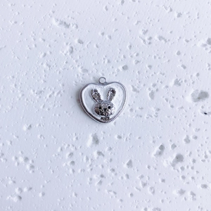 Detailed view of silver heart pendant with a cute rabbit head for DIY jewelry making