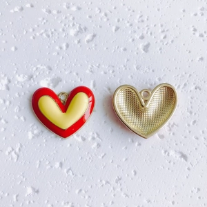 Detailed front and back view of a red and yellow heart-shaped enamel jewelry charm