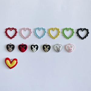 Close-up of DIY heart pendants with rabbit relief and colorful hollow heart frames