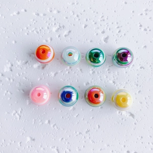 Macro detail of colorful aurora acrylic bubble beads with iridescent pearl glaze finish