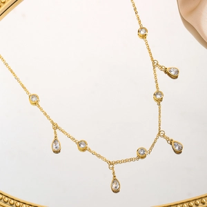 Elegant gold titanium steel necklace with water drop cubic zirconia charms on mirror