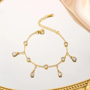 Macro detail of gold-plated stainless steel bracelet with teardrop cubic zirconia charms