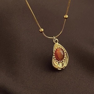 Collier vintage en œil de tigre doré avec pendentif goutte sur tissu de soie brun