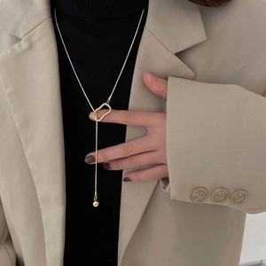 Minimalist gold tassel sweater necklace with geometric ring and bead pendant for women
