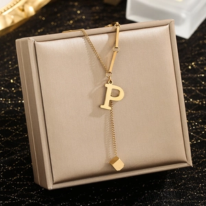 Gold stainless steel necklace with letter P pendant on champagne satin jewelry box