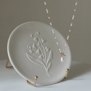 Elegant gold chain necklace with freshwater pearls and OT toggle clasp featuring a pearl drop