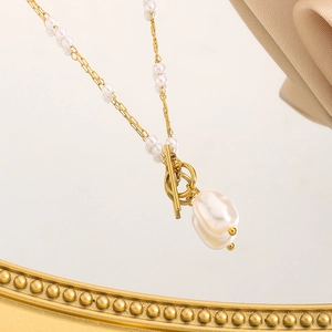 Chic pearl OT buckle necklace with baroque pearl pendant on champagne silk background