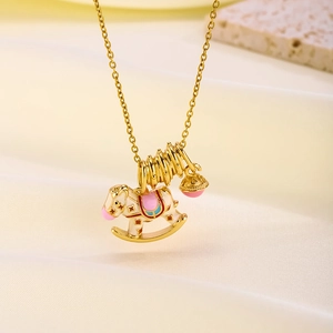 Charming gold-plated horse and bell pendant necklace on premium silk background