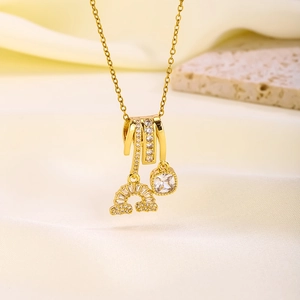 Macro detail of gold plated rainbow butterfly pendant with shimmering zircon pavé