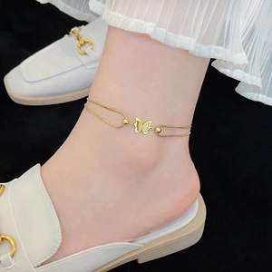 Double-layered gold stainless steel anklet with butterfly pendant worn on the ankle