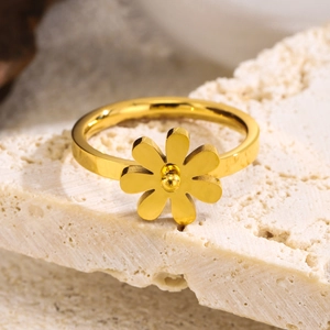 Minimalist golden stainless steel daisy flower ring on natural white stone base