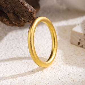 Matte gold titanium steel minimalist ring displayed on a natural Zen background