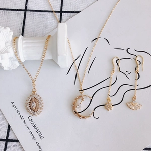 Gold plated moon star and sun pendant jewelry set with cubic zirconia stones