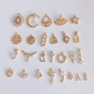 Detailed macro view of 18k gold plated DIY charms with cubic zirconia in various shapes