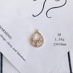 Detail of 23x16mm gold-plated teardrop pendant with cubic zirconia flower inlay