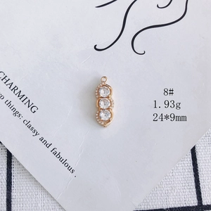 Detailed view of gold plated pendant with three zircons measuring 24x9mm and weighing 1.93g