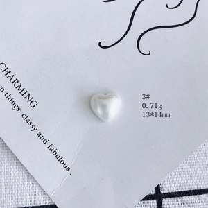 Macro shot of 13x14mm iridescent heart resin bead on display card for DIY jewelry